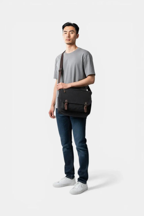 RAVIKEN black waterproof canvas men's messenger bag with PU leather accents and magnetic flap closure.